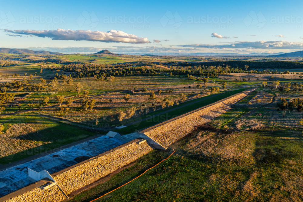 Aerial scene showcasing the Lake Keepit dam wall leading into the surrounding rural landscape - Australian Stock Image