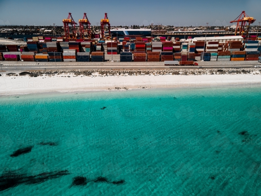 Aerial shot over the water to Fremantle Port and shipping containers - Australian Stock Image