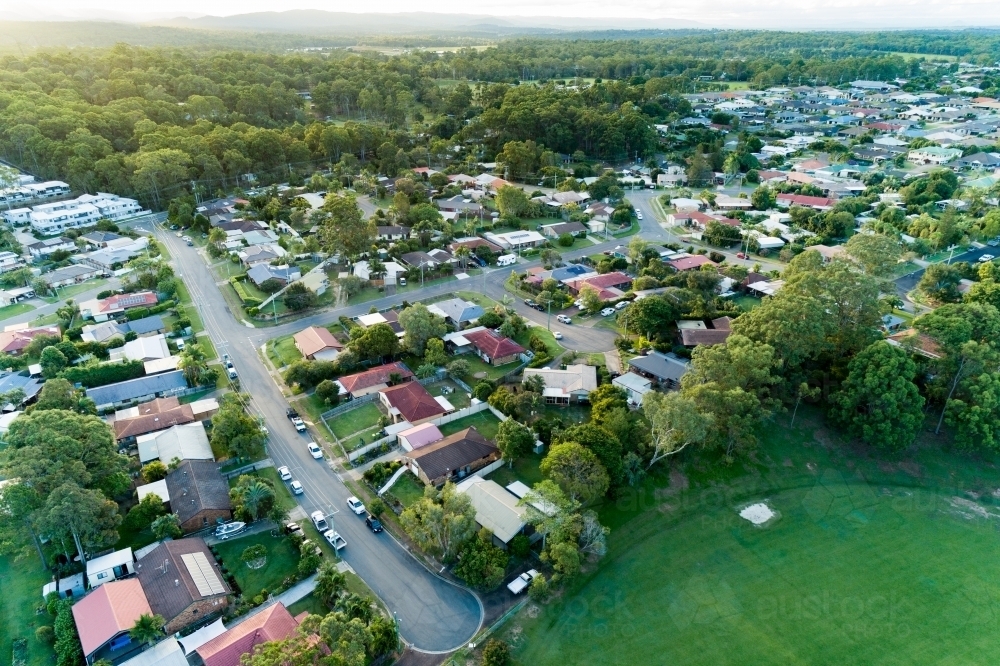 Aerial suburban cul-de-sac and sports field at dusk. - Australian Stock Image