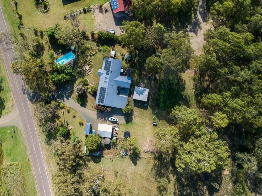 Aerial top down view of rural property with house with solar panels on roof - Australian Stock Image