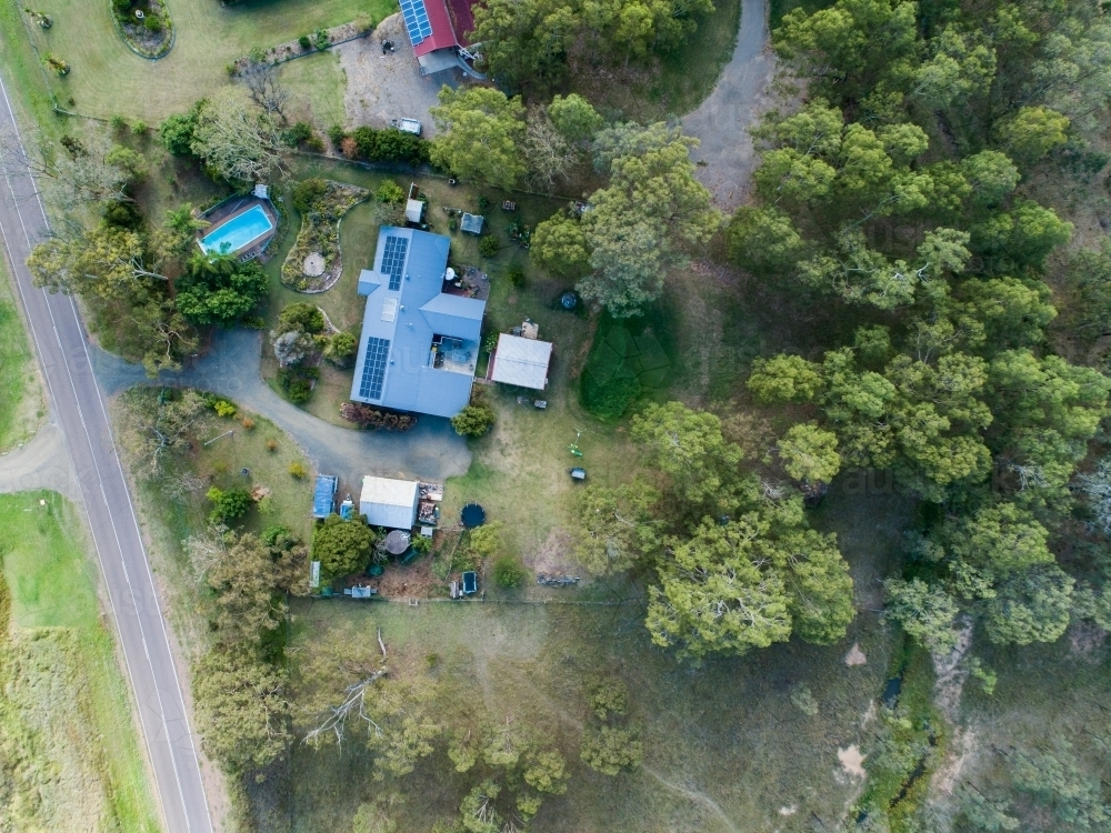 Aerial top down view of rural property with house with solar panels on roof - Australian Stock Image
