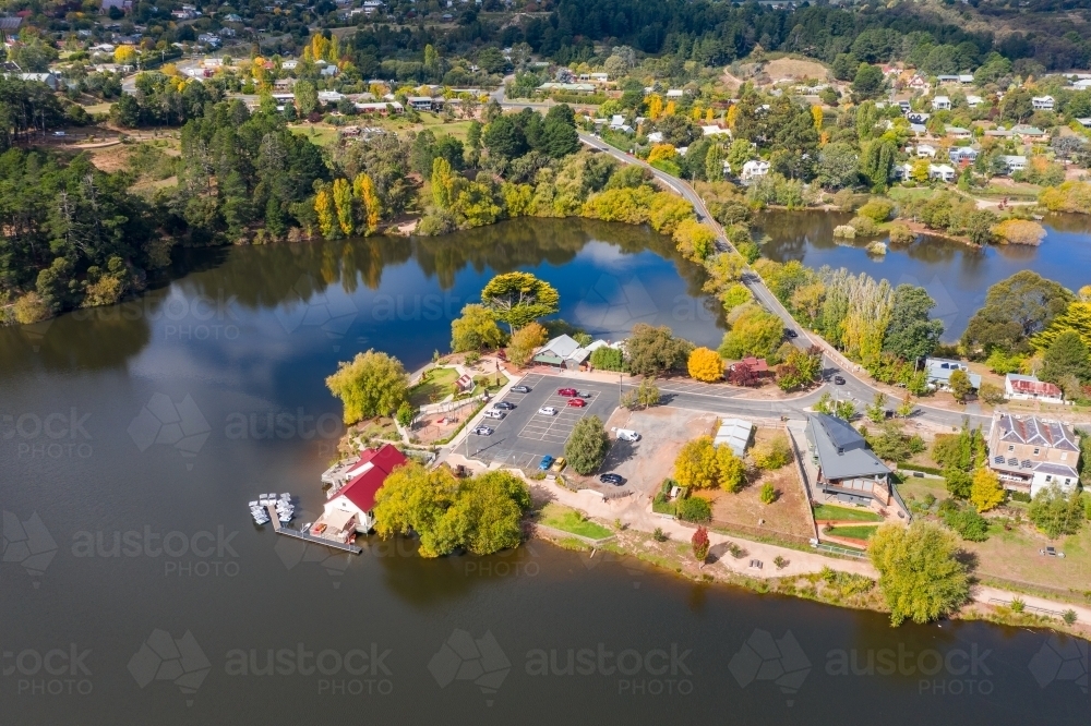 Aerial view a boathouse and walking tracks around an island in a lake - Australian Stock Image