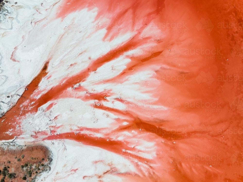 Red Radiating Pattern Image of Aerial view a colourful pattern of red water radiating into a ...