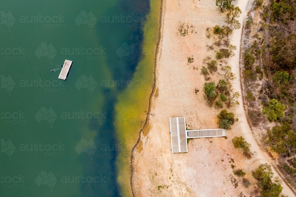 Aerial view a pontoon and walking track along the edge of a reservoir - Australian Stock Image