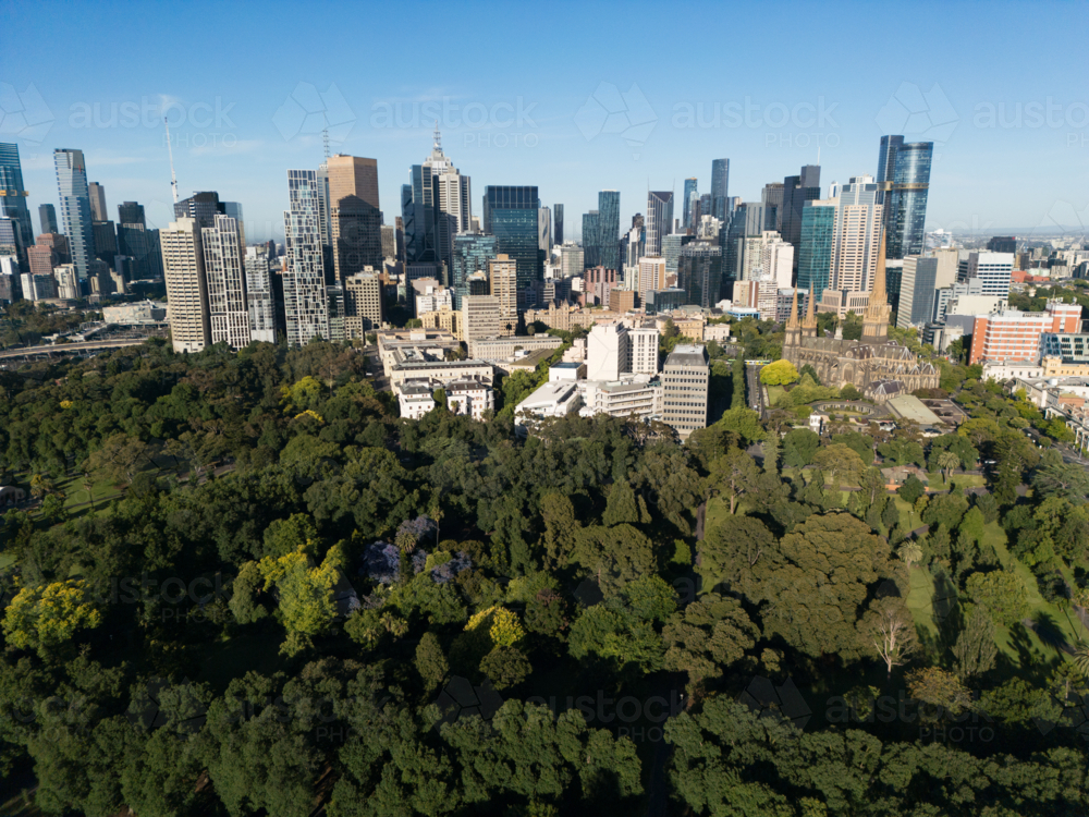 Aerial view across the Fitzroy Gardens towards buildings of Melbourne CBD - Australian Stock Image
