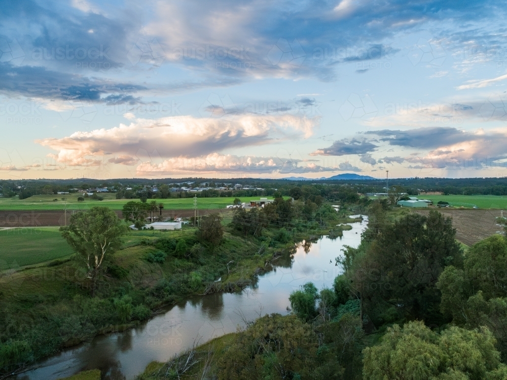 Aerial view along Hunter River in Singleton Hunter Valley at dusk during overcast sunset - Australian Stock Image