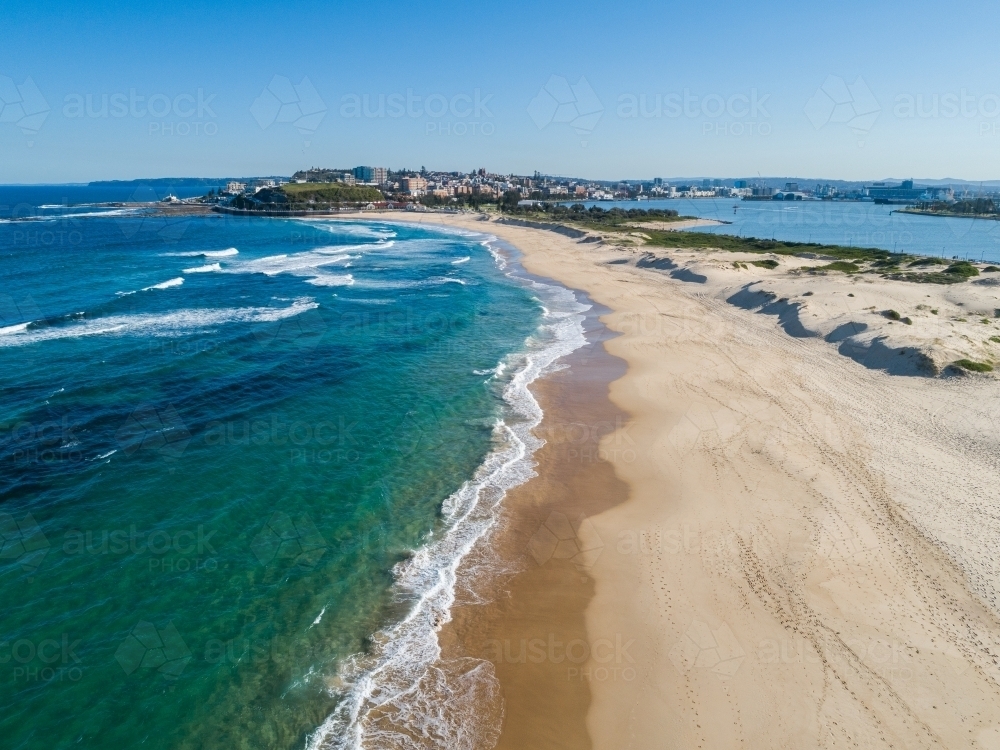 Aerial view along Nobbys Beach Newcastle on quiet sunlit winter day looking towards the city - Australian Stock Image