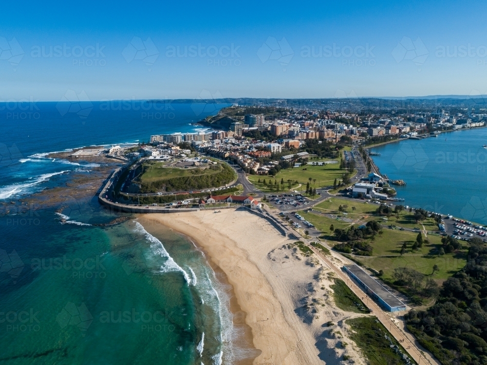 Aerial view along Nobbys Beach Newcastle on quiet sunlit winter day looking towards the city - Australian Stock Image