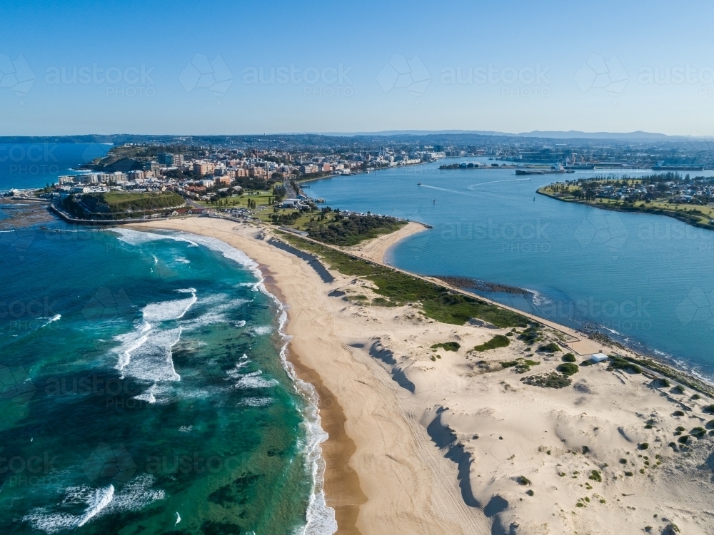Aerial view along Nobbys Beach Newcastle on quiet sunlit winter day looking towards the city - Australian Stock Image