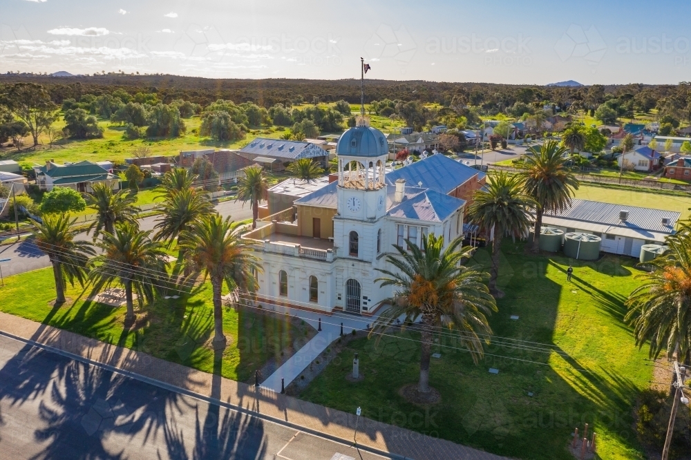 Aerial view an historic Town Hall in a regional town surrounded by palm trees - Australian Stock Image