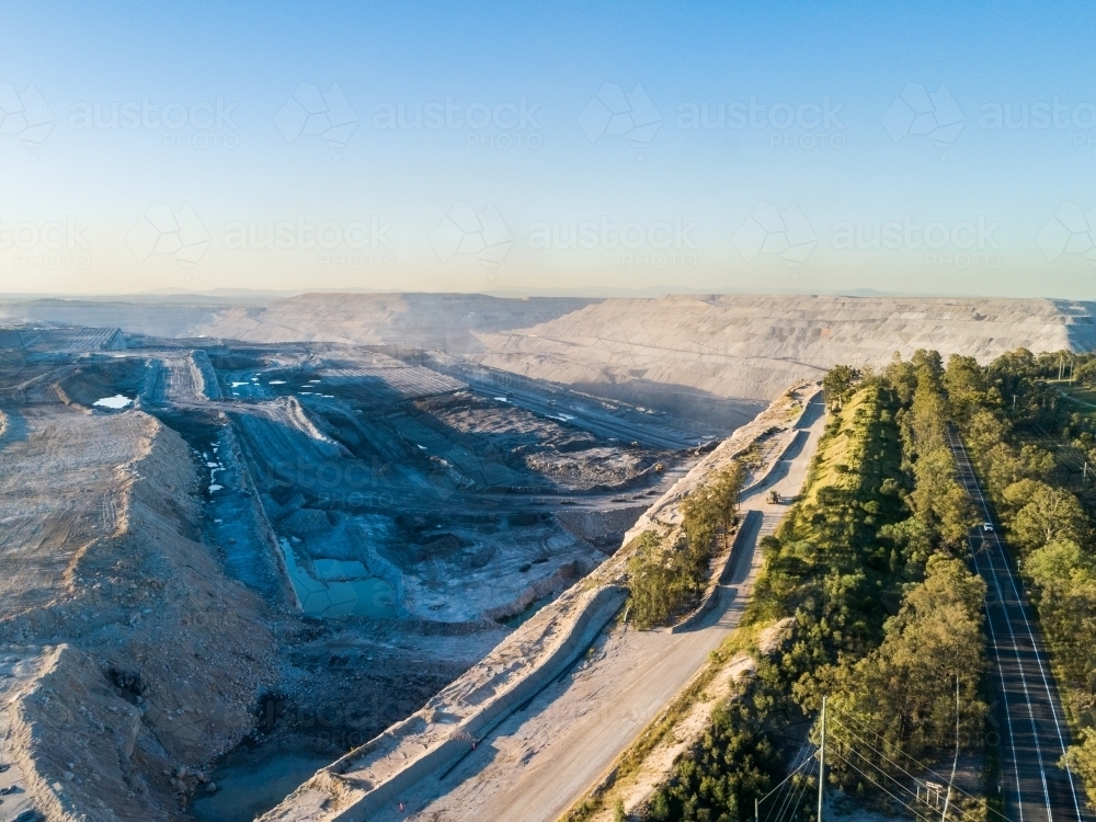 Aerial view looking towards dusty open cut coal mine pit - Australian Stock Image