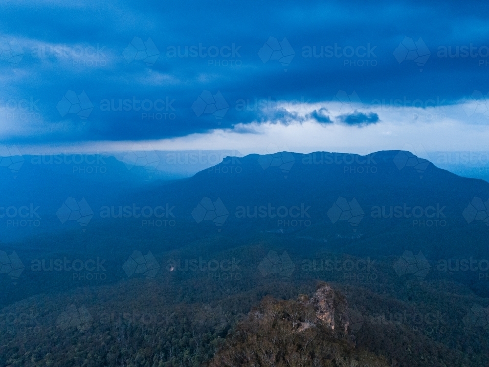 Aerial view looking towards mount solitary in Blue mountains with approaching storm - Australian Stock Image