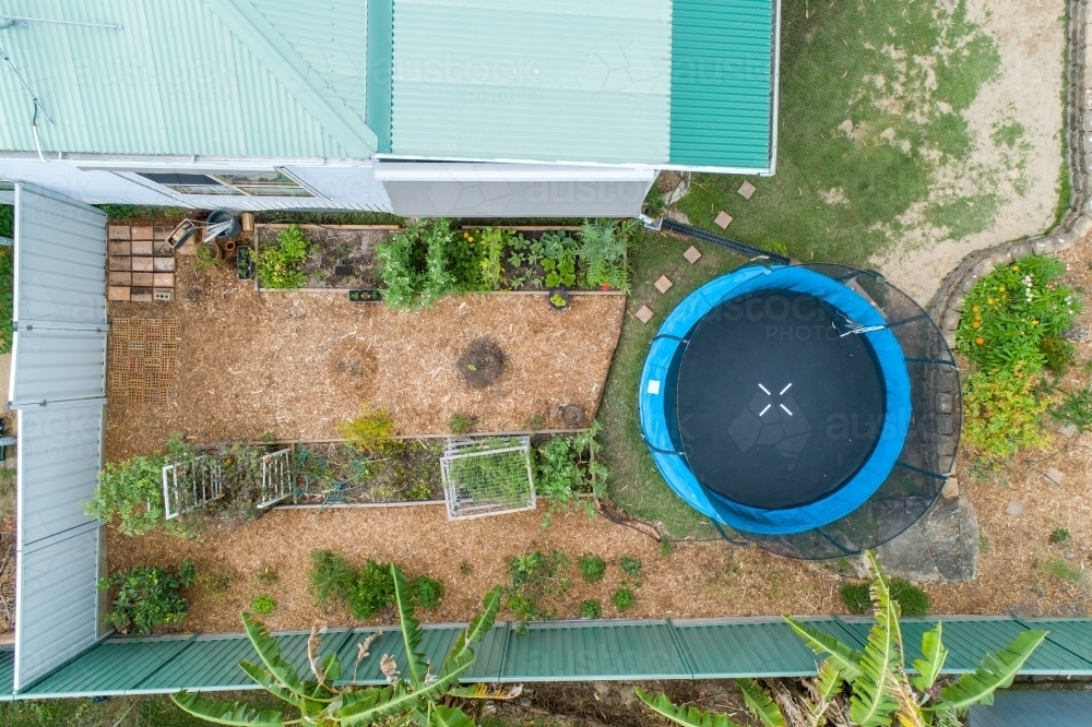 Aerial view of a backyard vegetable patch and trampoline. - Australian Stock Image