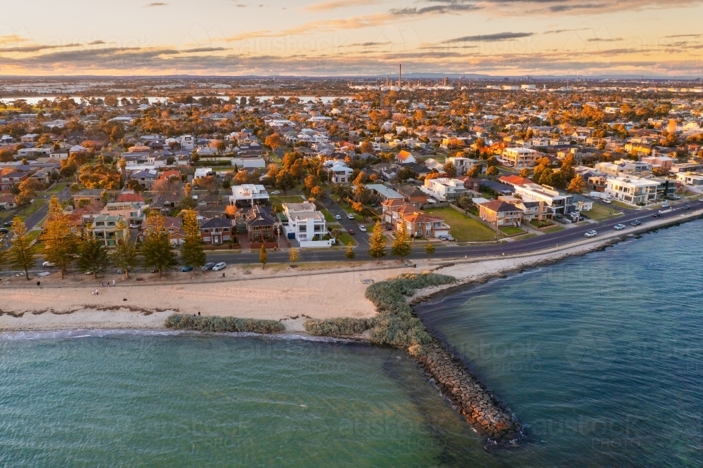 Aerial view of a bay side beach and town at dusk - Australian Stock Image