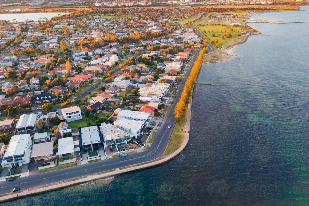 Aerial view of a bay side suburb and esplanade at dusk - Australian Stock Image