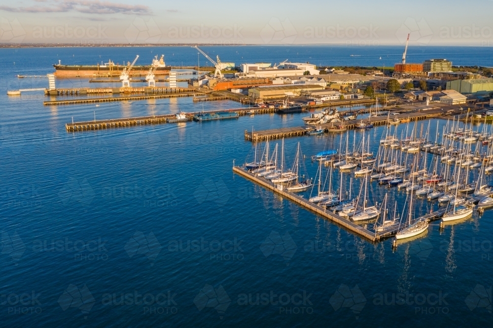 Image of Aerial view of a bay side yacht club with rows of boats lined ...