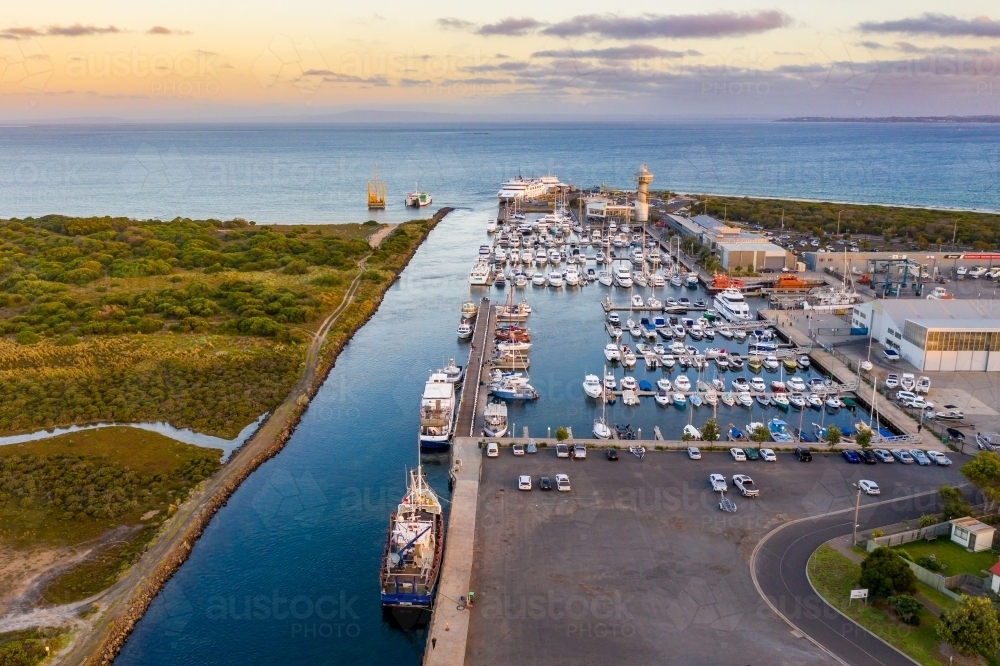 Aerial view of a boats and yachts anchored at a coastal marina - Australian Stock Image