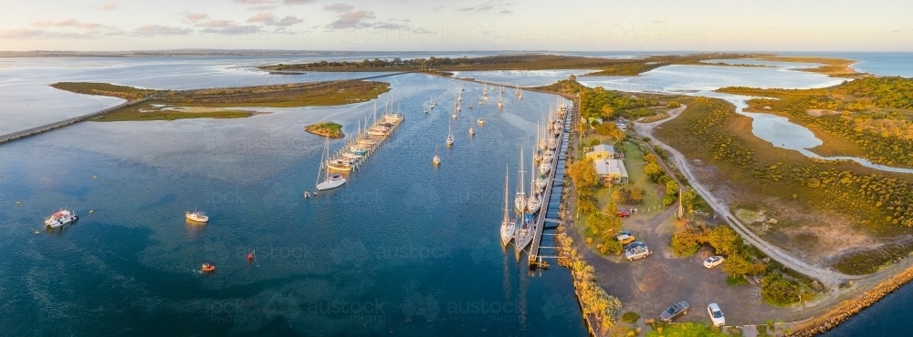 Aerial view of a boats and yachts anchored at a coastal marina - Australian Stock Image