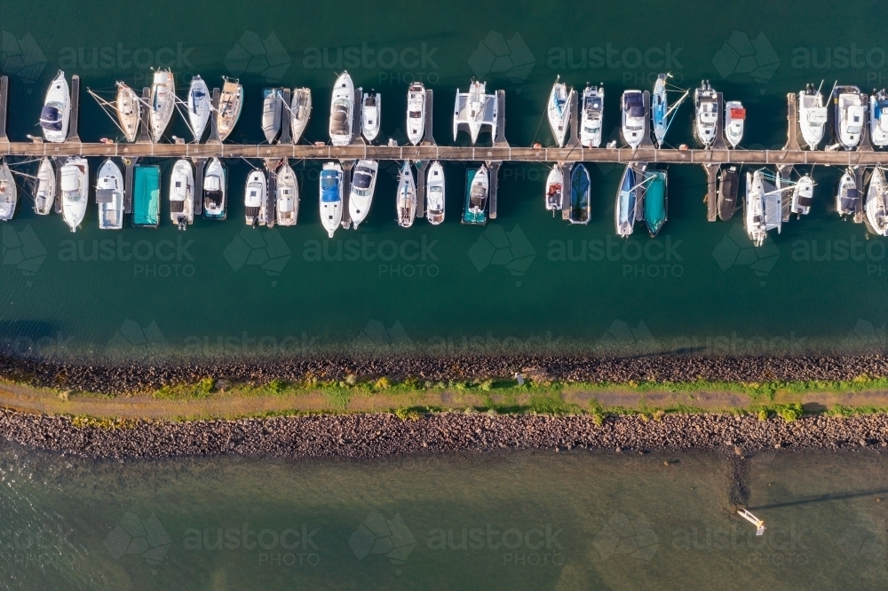 Image of Aerial view of a boats and yachts lined up along jettys at a ...