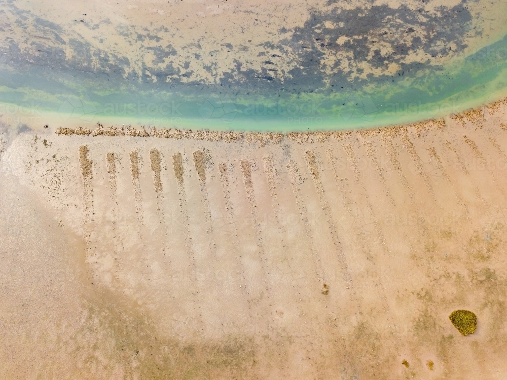 Aerial view of a channel on the beach at low tide - Australian Stock Image