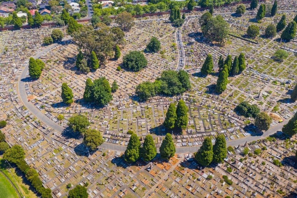 Aerial view of a circular road winding through a large cemetery - Australian Stock Image