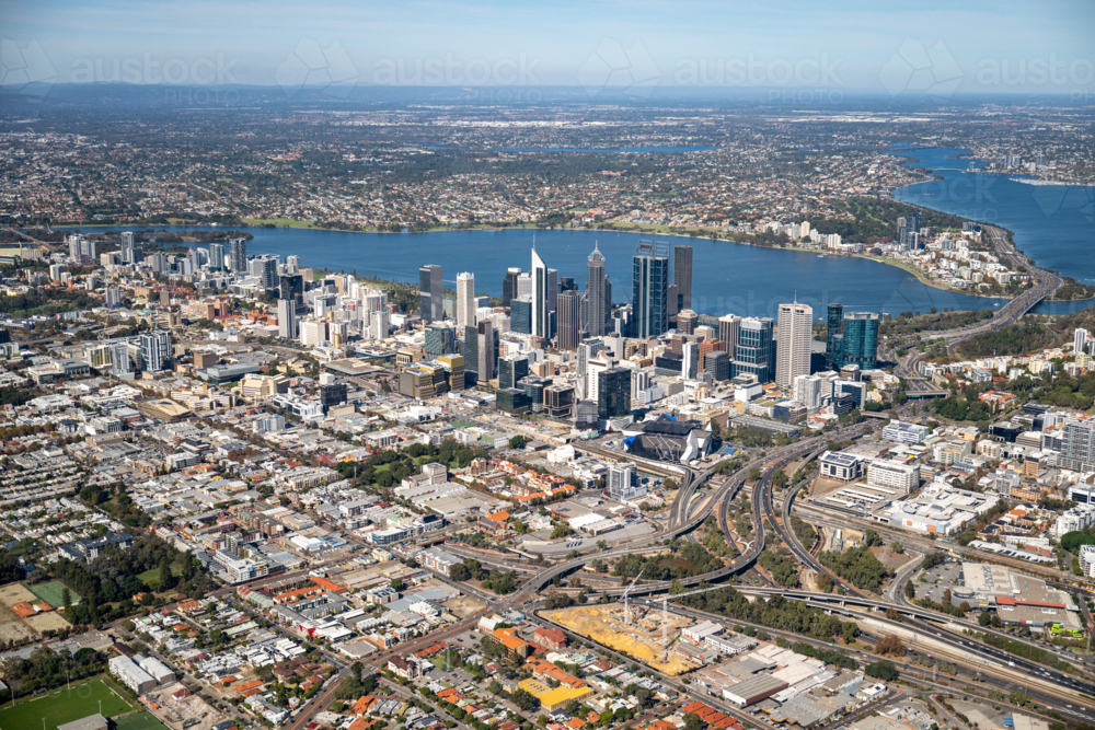 Aerial view of a city CBD and suburbs beside a wide river stretching to the distant horizon - Australian Stock Image