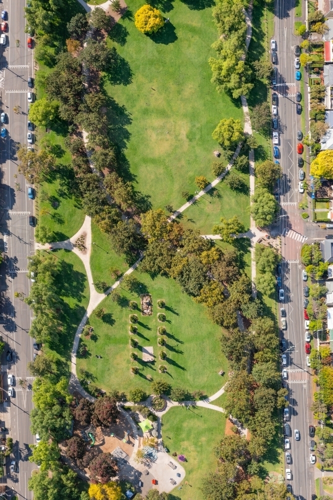 Aerial view of a city park with walking tracks and tree lines - Australian Stock Image