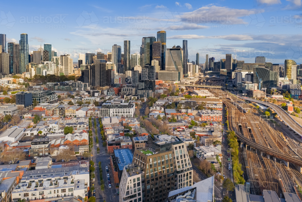 Aerial view of a city skyline and low rise buildings alongside a major railway link at Melbourne - Australian Stock Image
