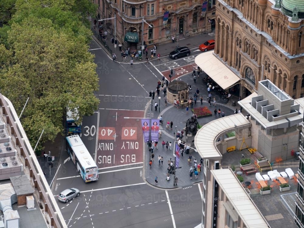 Aerial view of a city street intersection with pedestrians and buses - Australian Stock Image