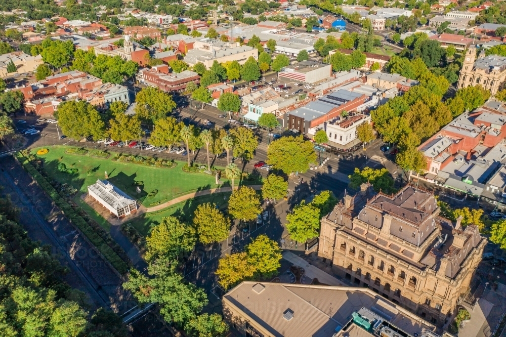 Aerial view of a city with historic buildings, a park  and tree lined streets - Australian Stock Image