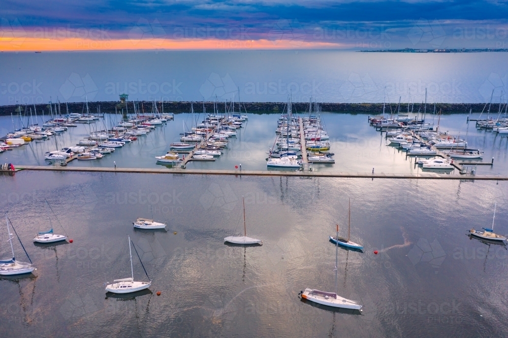 Aerial view of a coastal marina at sunset - Australian Stock Image