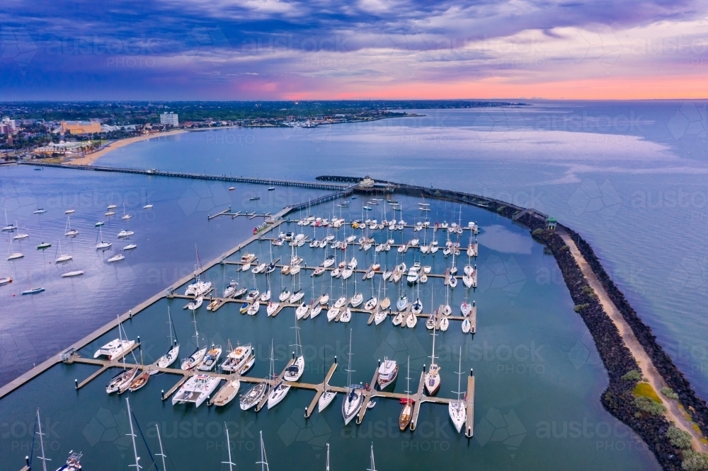 Aerial view of a coastal marina at sunset - Australian Stock Image
