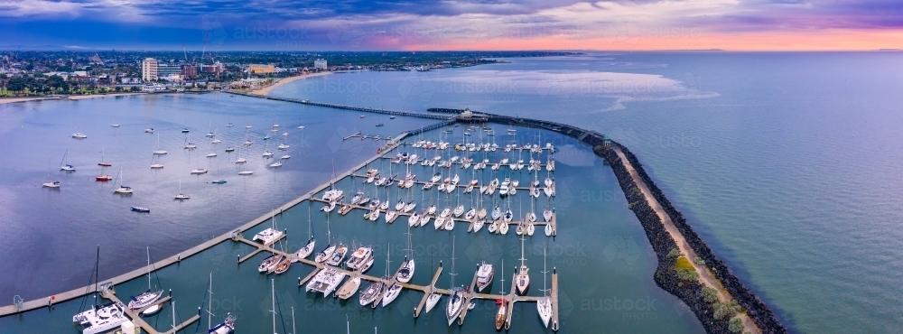 Aerial view of a coastal marina at sunset - Australian Stock Image