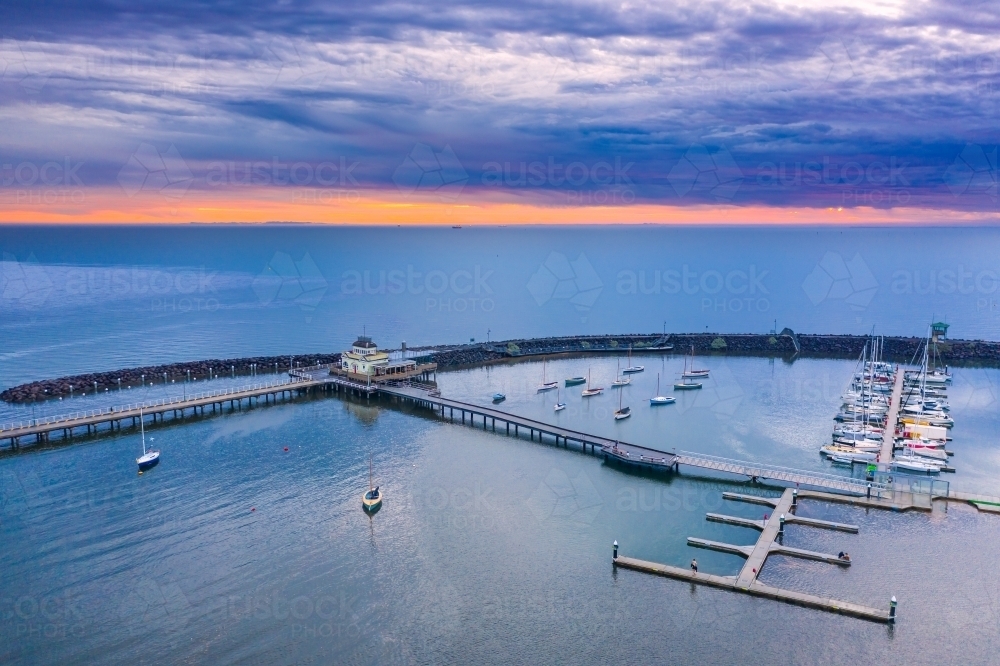 Aerial view of a coastal marina under a colourful sunset - Australian Stock Image
