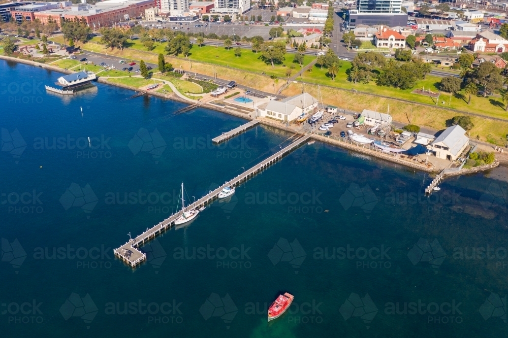 Aerial view of a coastal reserve with parks, boat sheds and jetties - Australian Stock Image