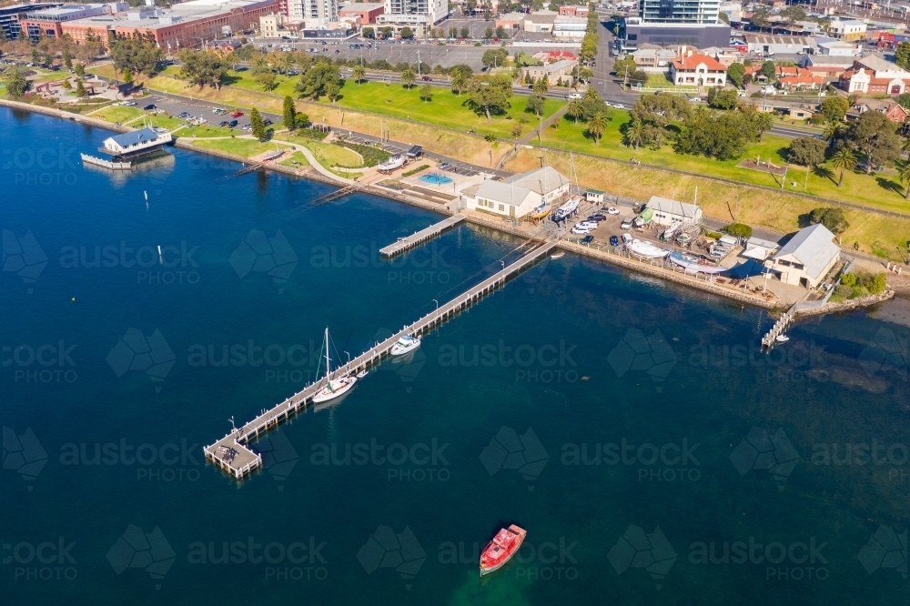 Aerial view of a coastal reserve with parks, boat sheds and jetties - Australian Stock Image