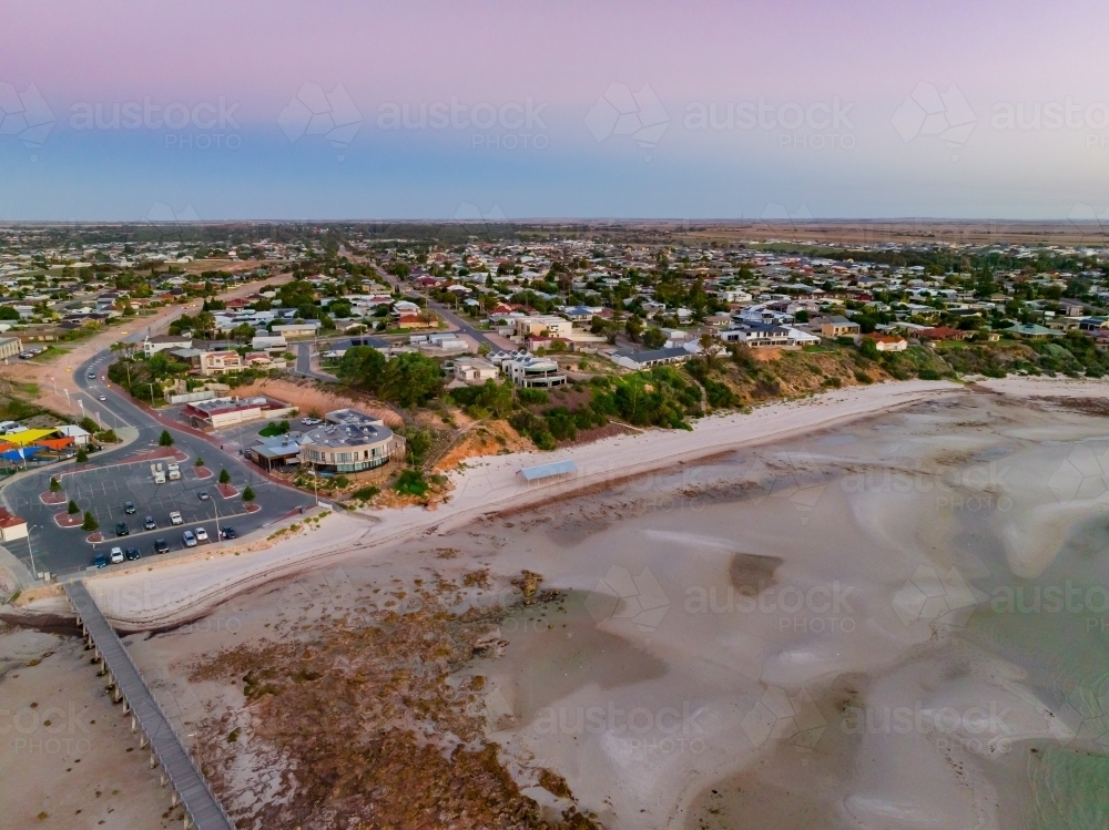 Aerial view of a coastal town above a sandy beach and coastline - Australian Stock Image