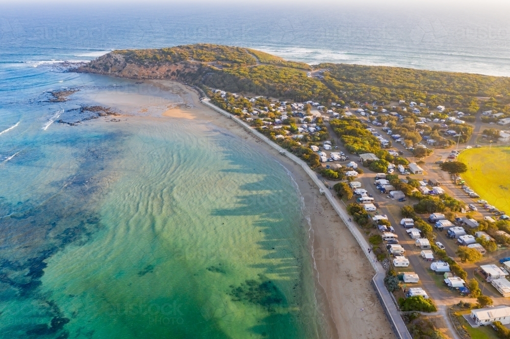 Aerial view of a coastal town and caravan park near a river mouth - Australian Stock Image