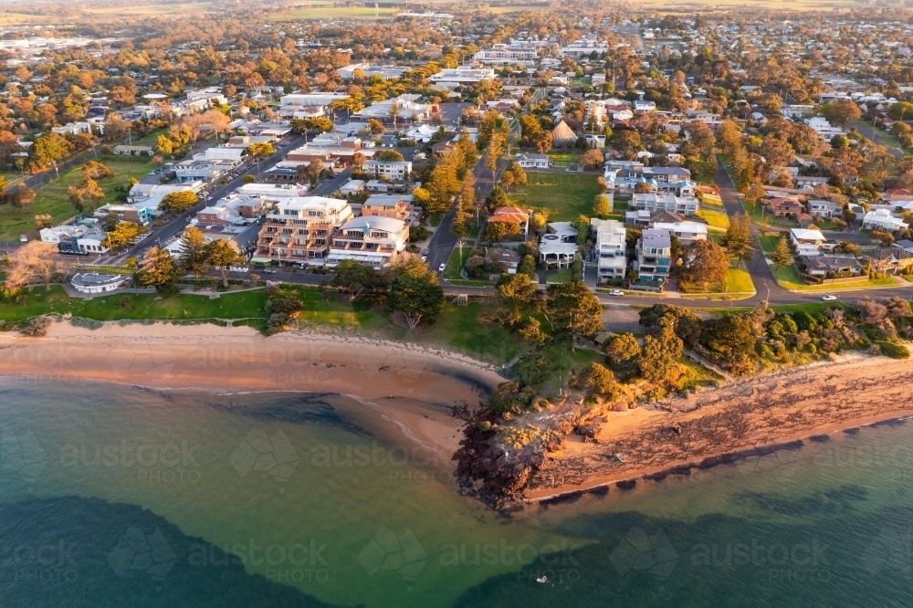Aerial view of a coastal town behind a bluff and a foreshore reserve - Australian Stock Image