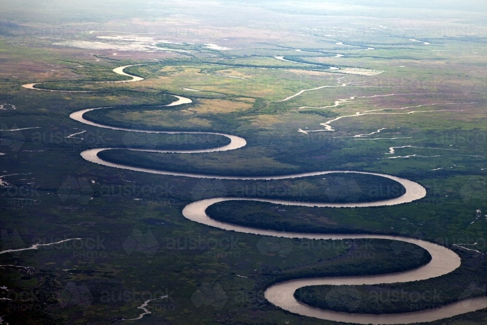 Image of Aerial view of a curving river system - Austockphoto