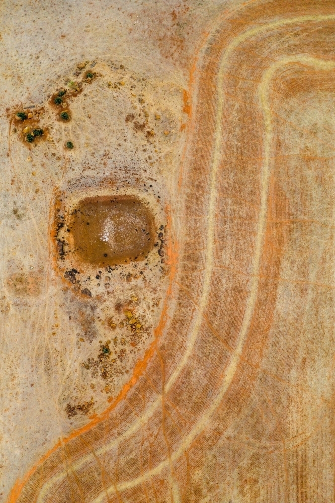 Aerial view of a dry dam next to wheel tracks on dried farmland. - Australian Stock Image