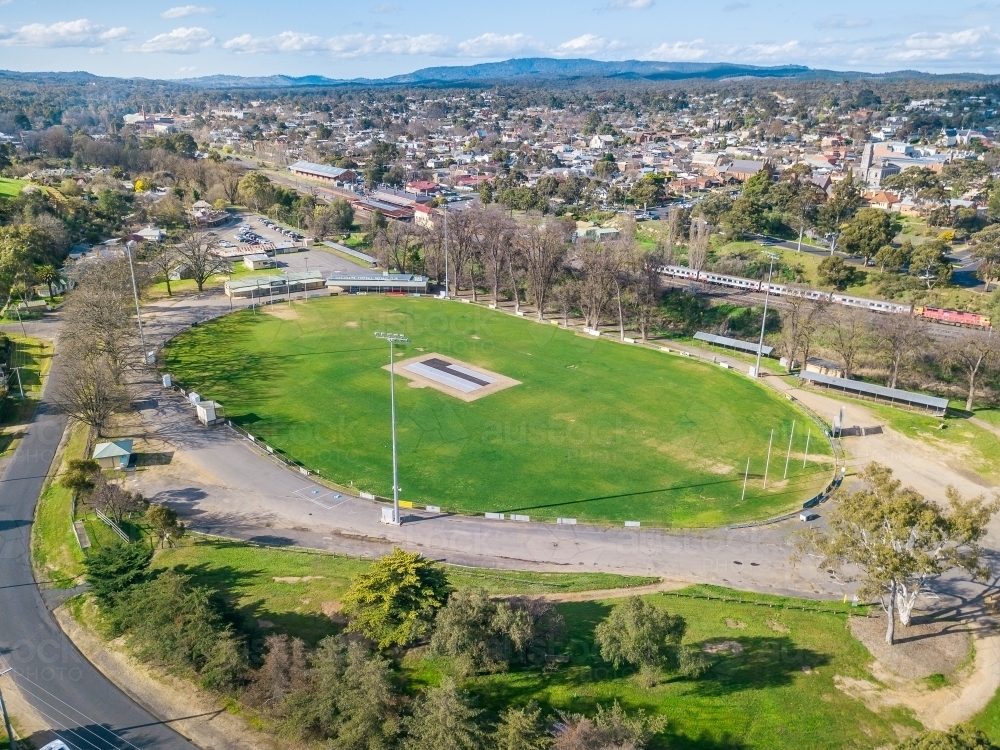 Image of Aerial view of a football oval next to a railway line Austockphoto