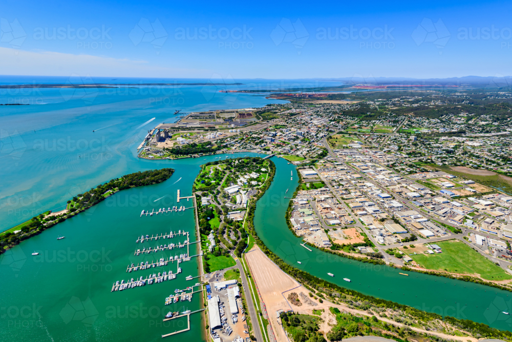 Aerial view of a Gladstone coastal town surrounded by winding waterways from Callemondah area - Australian Stock Image