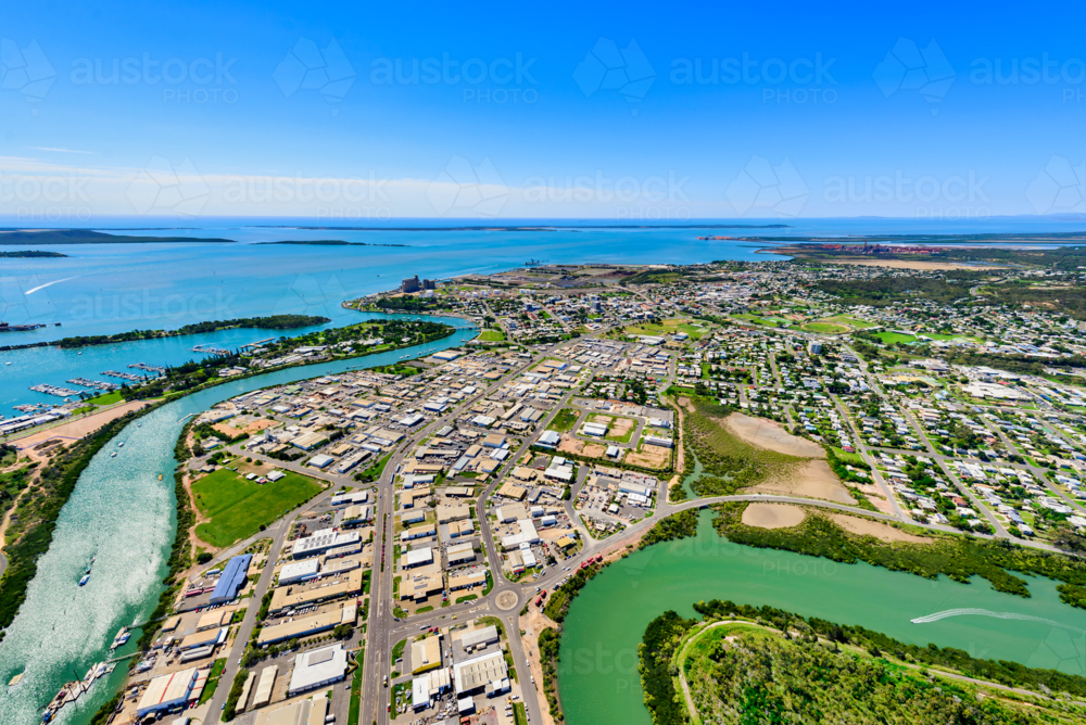 Aerial view of a Gladstone coastal town surrounded by winding waterways from Callemondah area - Australian Stock Image