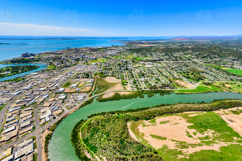 Aerial view of a Gladstone coastal town surrounded by winding waterways from Callemondah area - Australian Stock Image