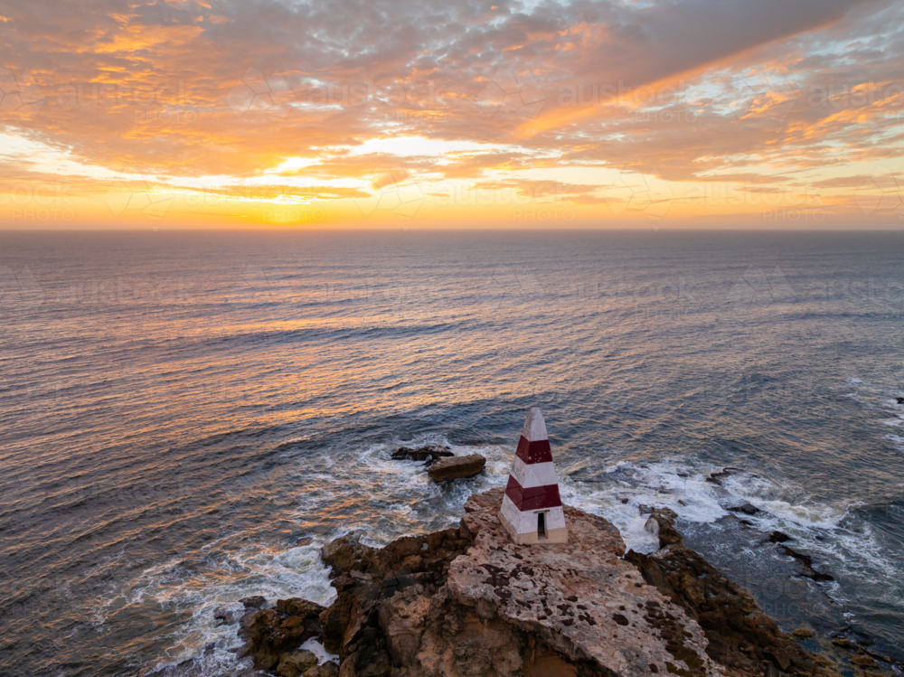 Image of Aerial view of a golden sunset sky over an obelisk monument on ...