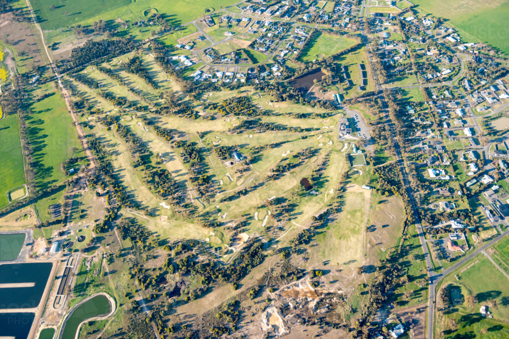 Aerial view of a golf course beside a regional town landscape. - Australian Stock Image