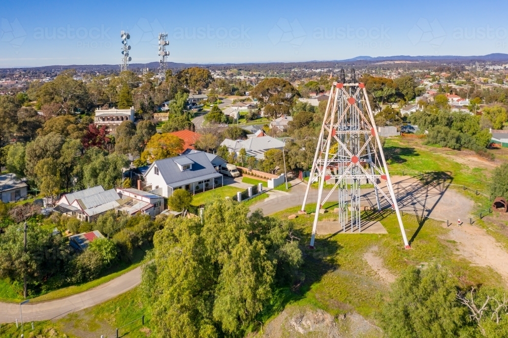 Aerial view of a historic mining poppet head on a hill top surrounded by walking tracks - Australian Stock Image