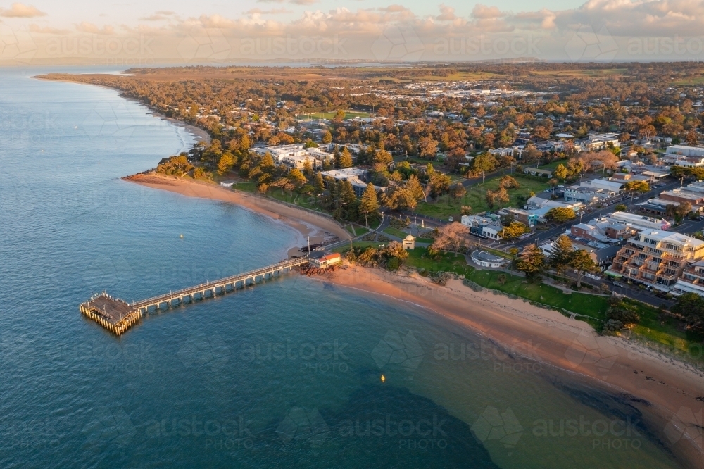 Image of Aerial view of a jetty jutting out from a beach side reserve ...