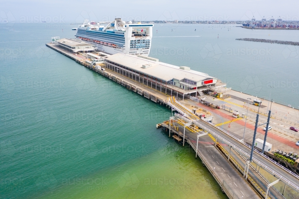 Aerial view of a large cruise ship docked at shipping terminal - Australian Stock Image